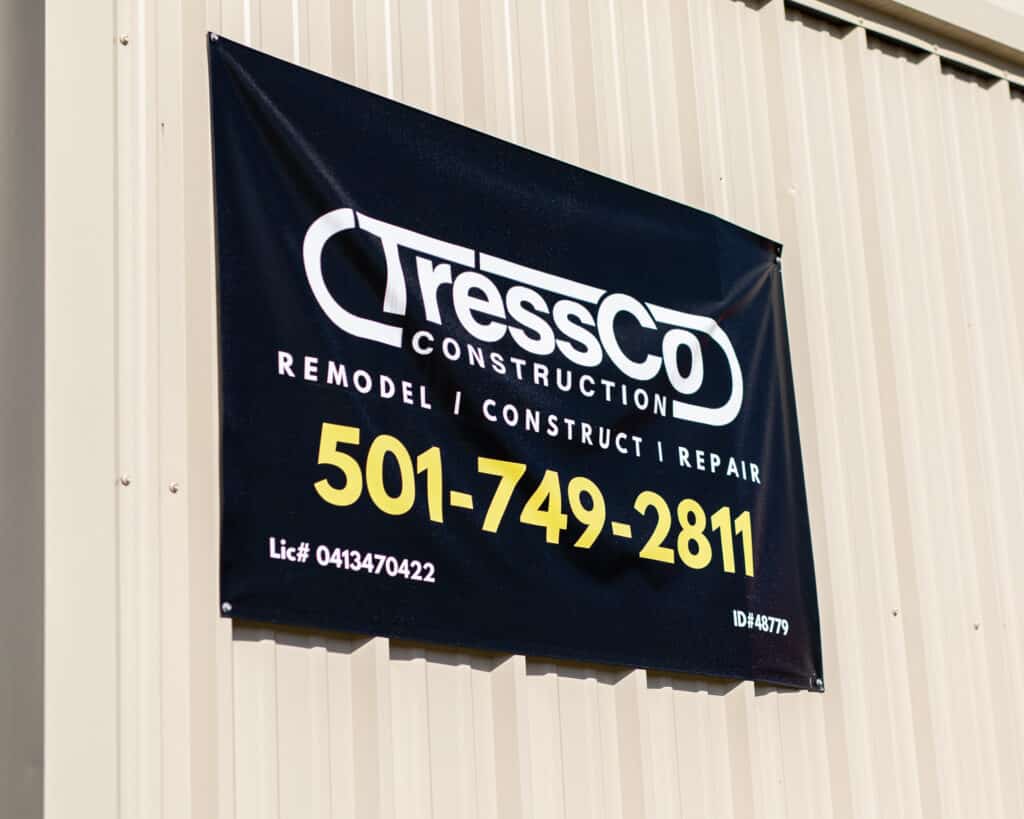 Sign hanging outside of TressCo Construction's Cabinet Shop. It says, "TressCo Construction - Remodel/Construct/Repair." Also includes the phone number, license number, and ID number.